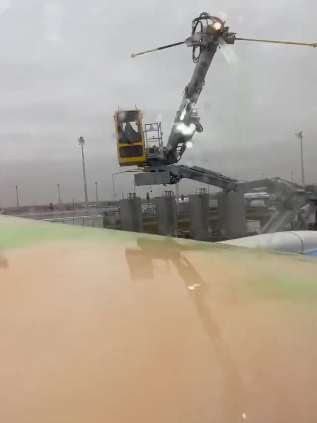 Airplanes get their wings sprayed with colourful chemicals on below